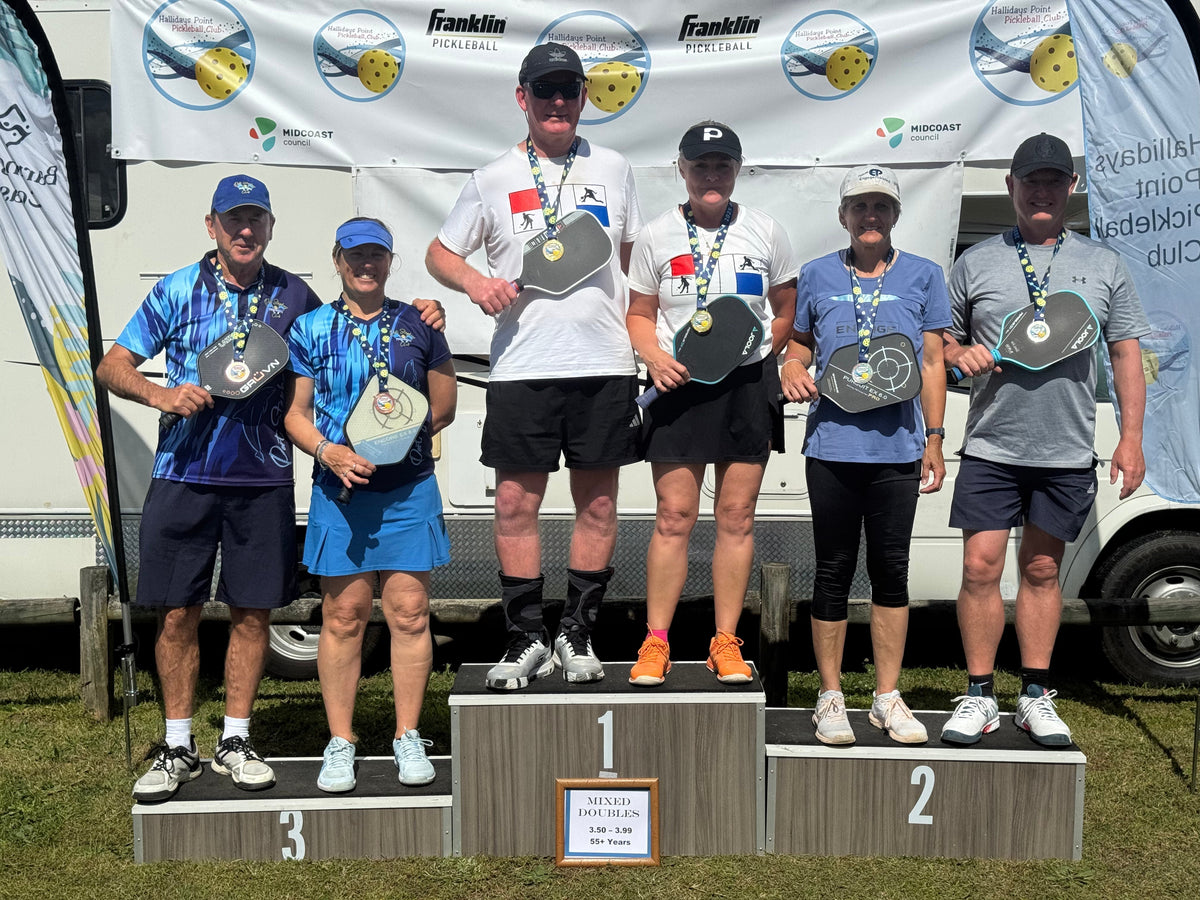 Holding gold in the mixed doubles at Barrington Coast tournament 50+ 3.49-3.55