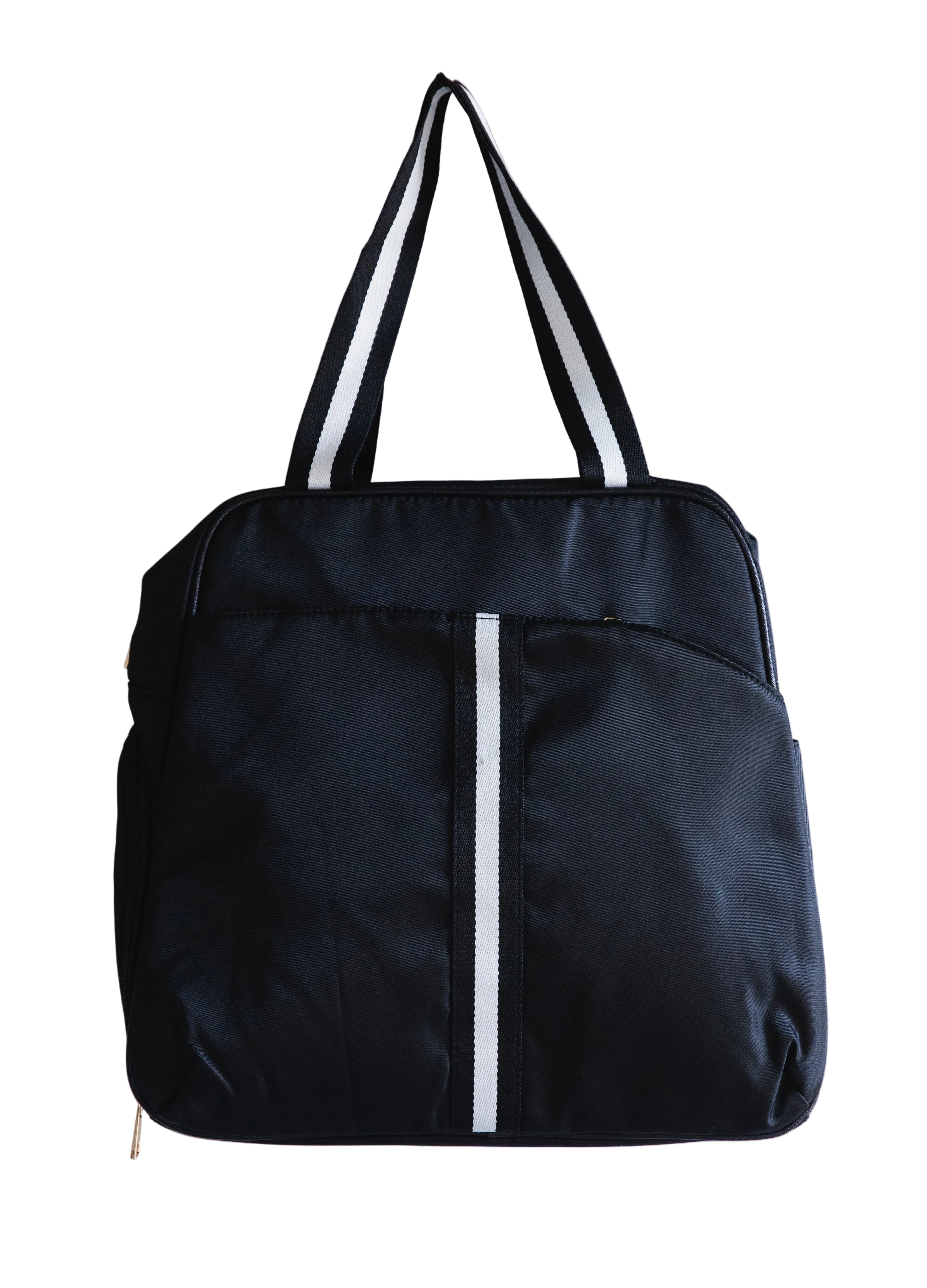 This pickleball bag features a sleek black nylon backpack, designed with functionality and style in mind. The backpack displays a smooth, solid black texture with a distinctive white stripe running horizontally along the front pocket, adding a touch of modern aesthetics. With several pockets within, this makes it perfect for organising yourself ready for the next competition.